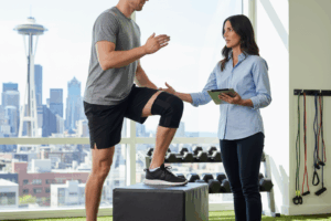 Progressive Seattle physical therapy for meniscus repair physical therapy: Patient performs box step-ups, crucial for return to sport after surgery under expert guidance.