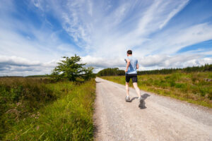 Person running on a dirt road